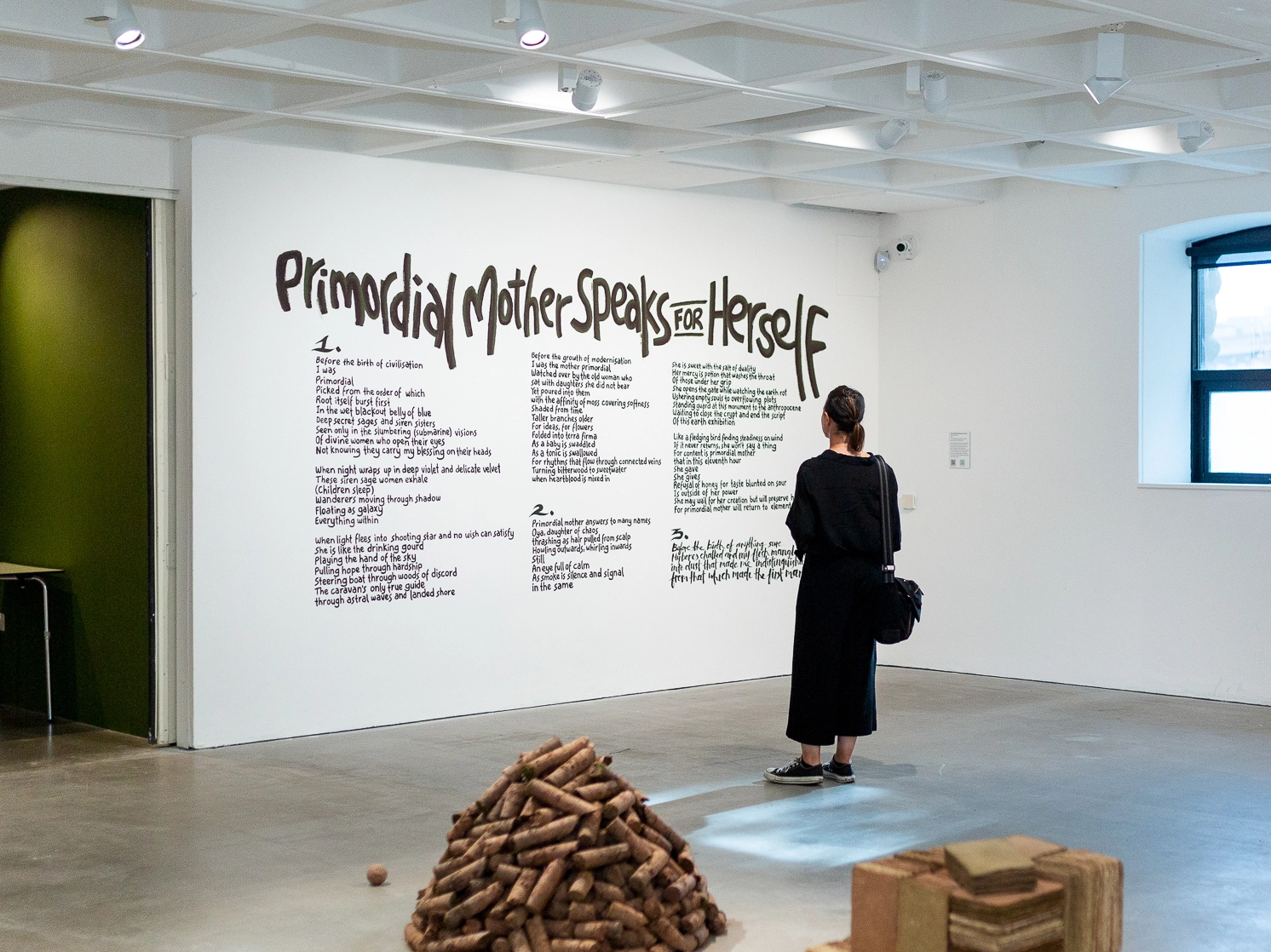 A patron reading Primordial Mother Speaks For Herself at Arnolfini